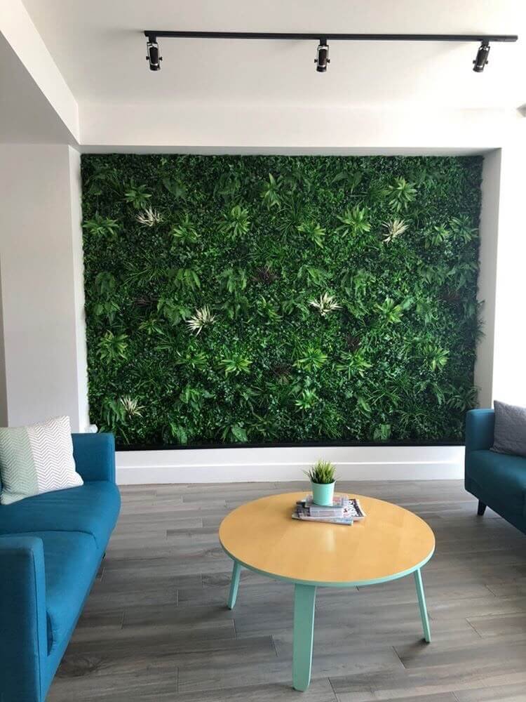 artificial green wall panel installedinto a living room
