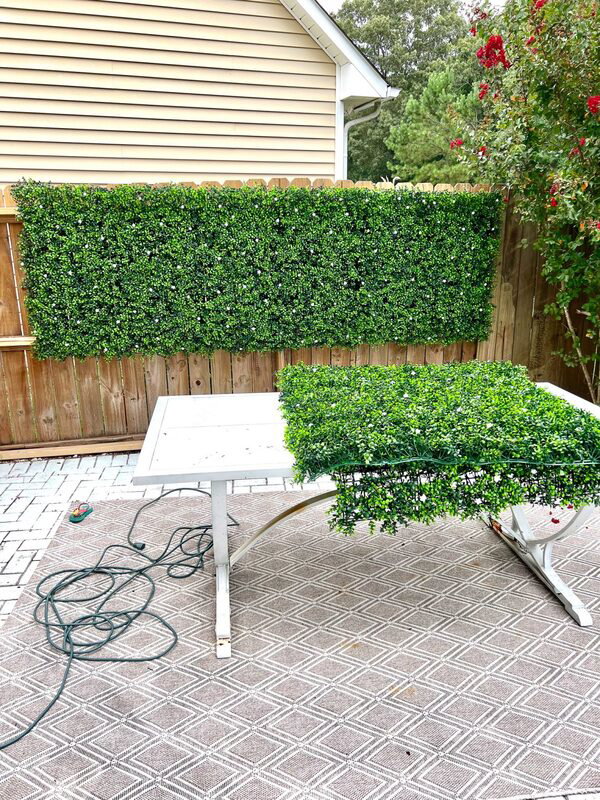 installing artificial green panels on wooden fence