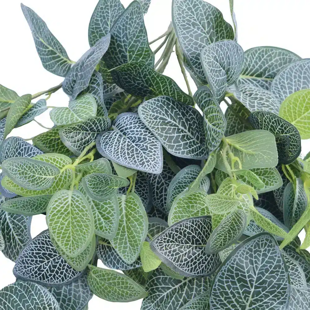 Close up of lifelike artificial foliage with intricate white veining on green leaves, ideal for indoor greenery decor