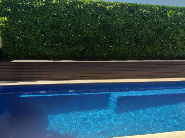 poolside faux hedge wall