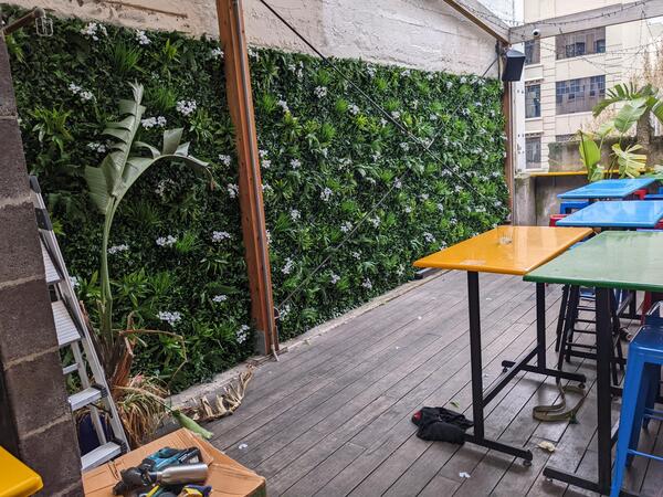 cafe brick wall decoration with vertical garden panels