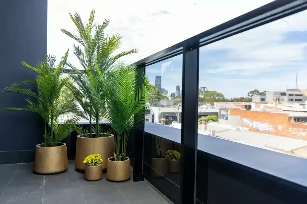 Gold Concrete Planters and Pots with Plants Potted Inside including artificial palm trees