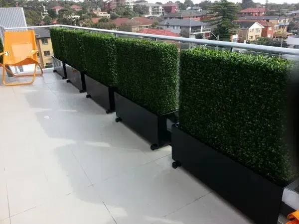 faux hedge on balcony