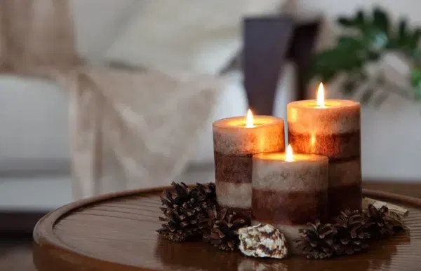 three lighted candles on coffee table