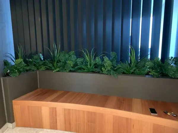 another angle of the office with artificial monstera split leaf philodendron